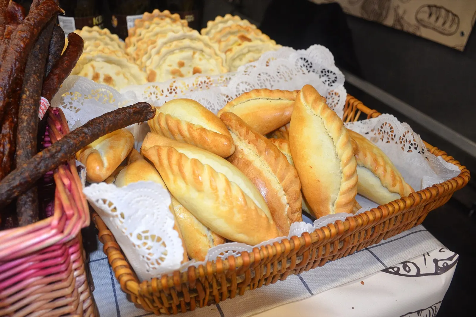 Golden crescent-shaped kibinai pastries from Trakai on a plate