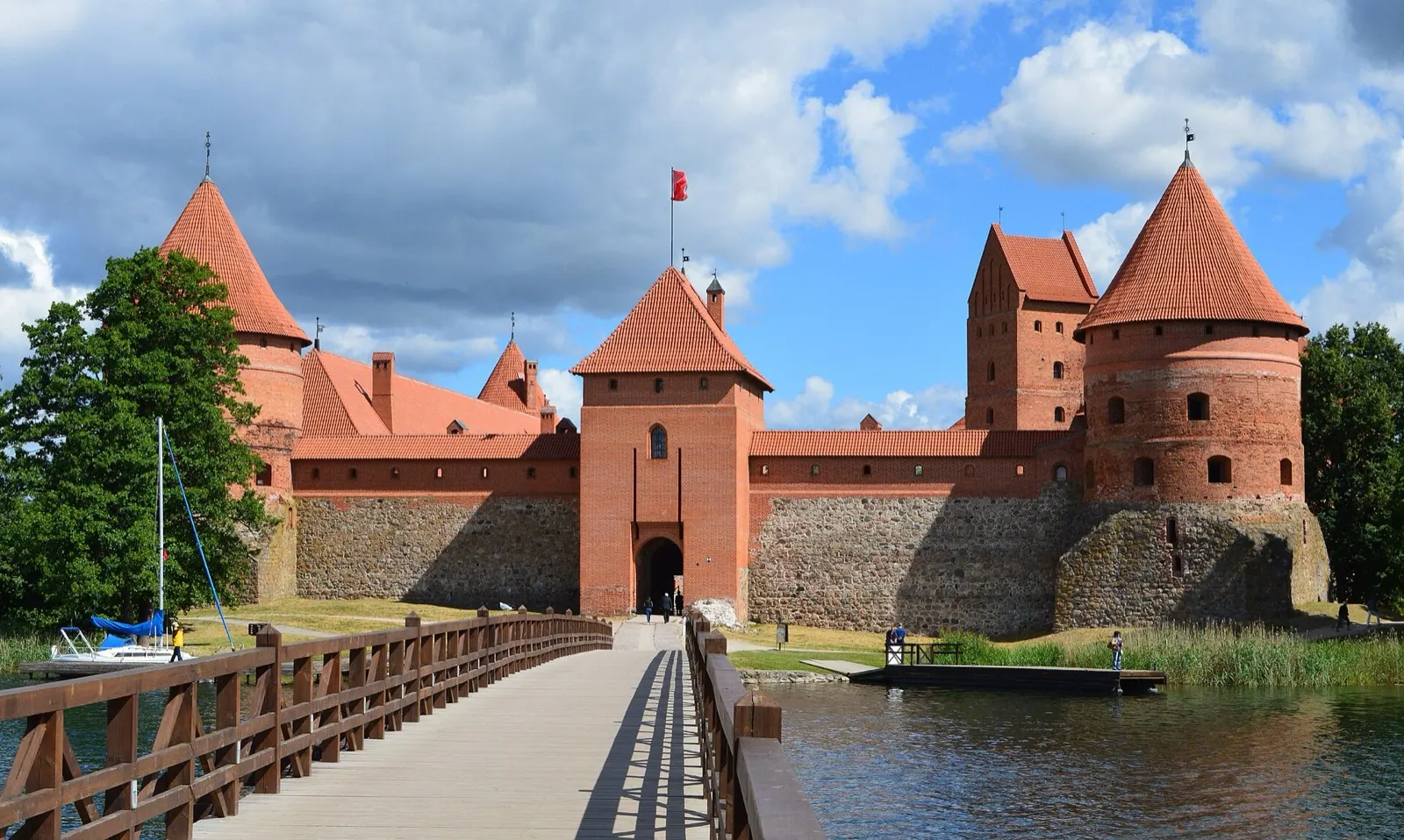 Red-brick Trakai Island Castle rising from Lake Galvė, seen across the water in summer